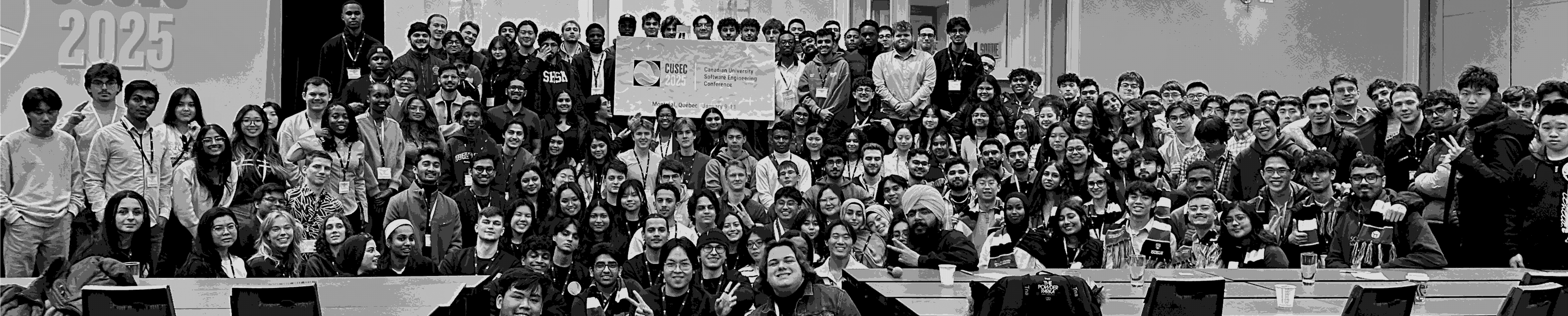 CUSEC attendees gathered for a group photo in a conference hall.
